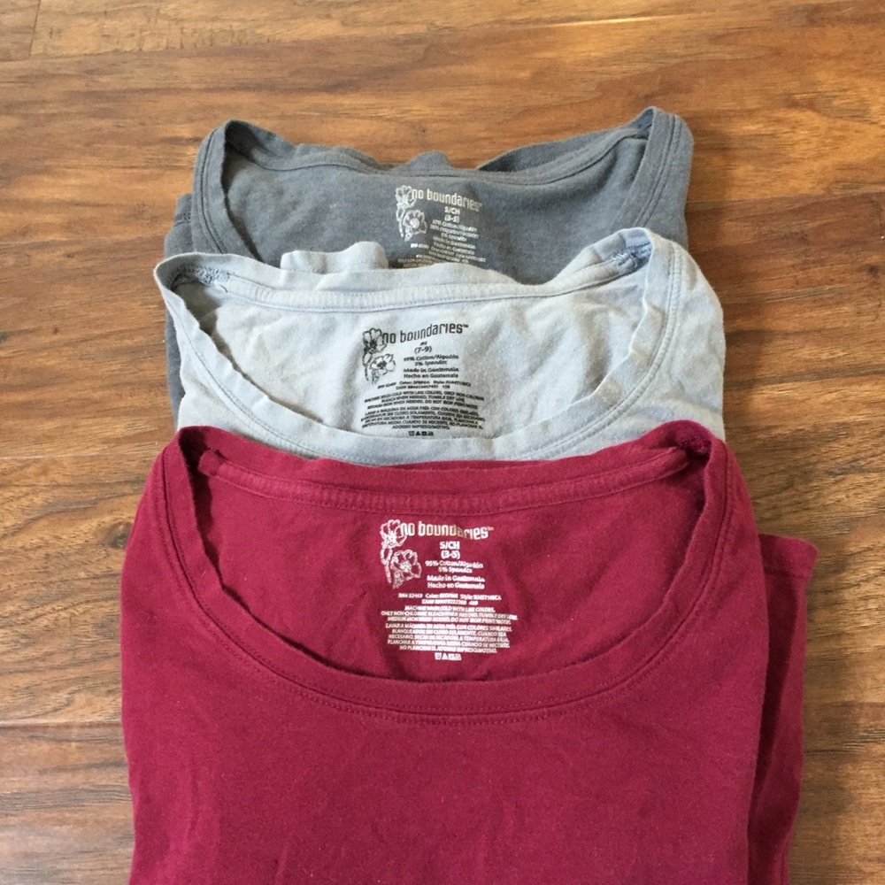 A bundle of three long sleeve shirts